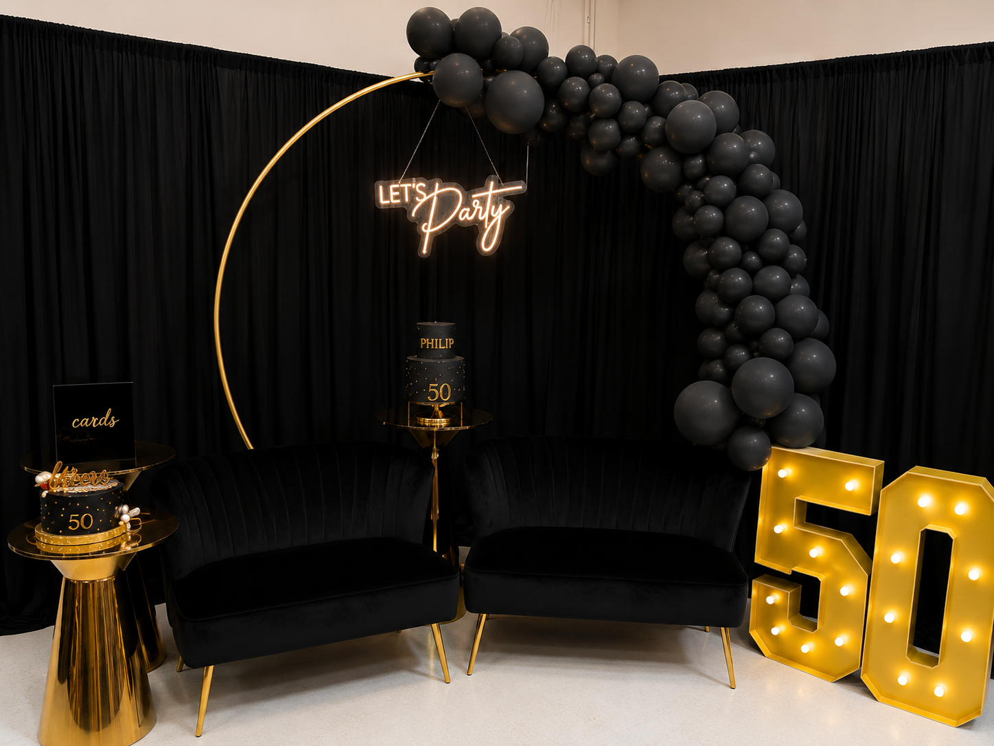 Black and gold birthday lounge setup